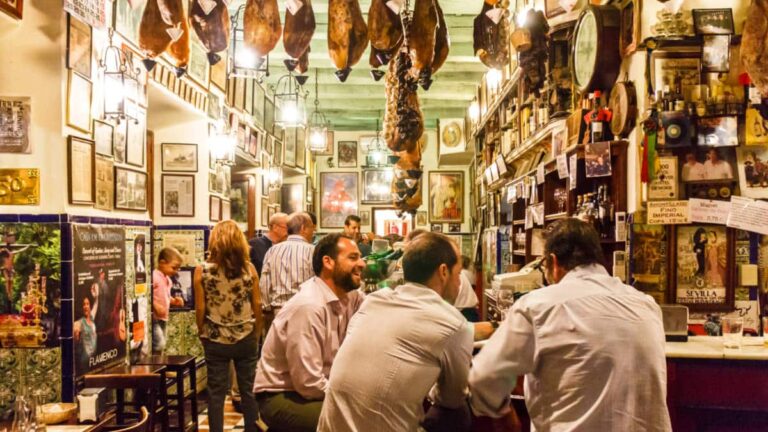 Customers eating and drinking in a tapas bar in Seville