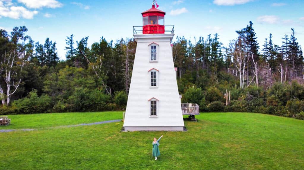 The author Taylor Herperger, posing in front of the Cape Bear Lighthouse in Prince Edward Island