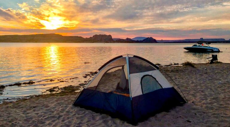 View of a tent near a shoreline during sunset