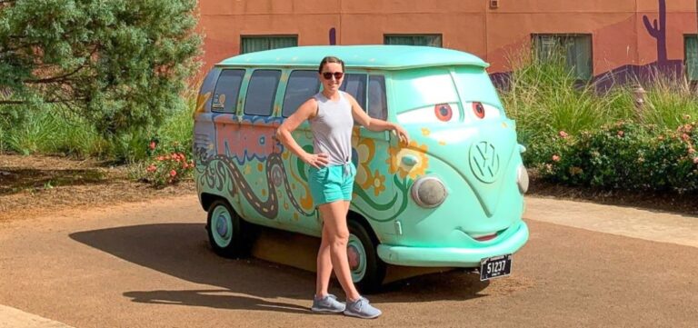 The author Katie, posing for a photo next to Fillmore, the Volkswagen bus