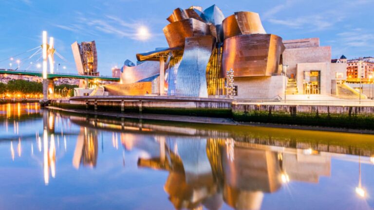 The Guggenheim Museum reflecting on the water during sunrise