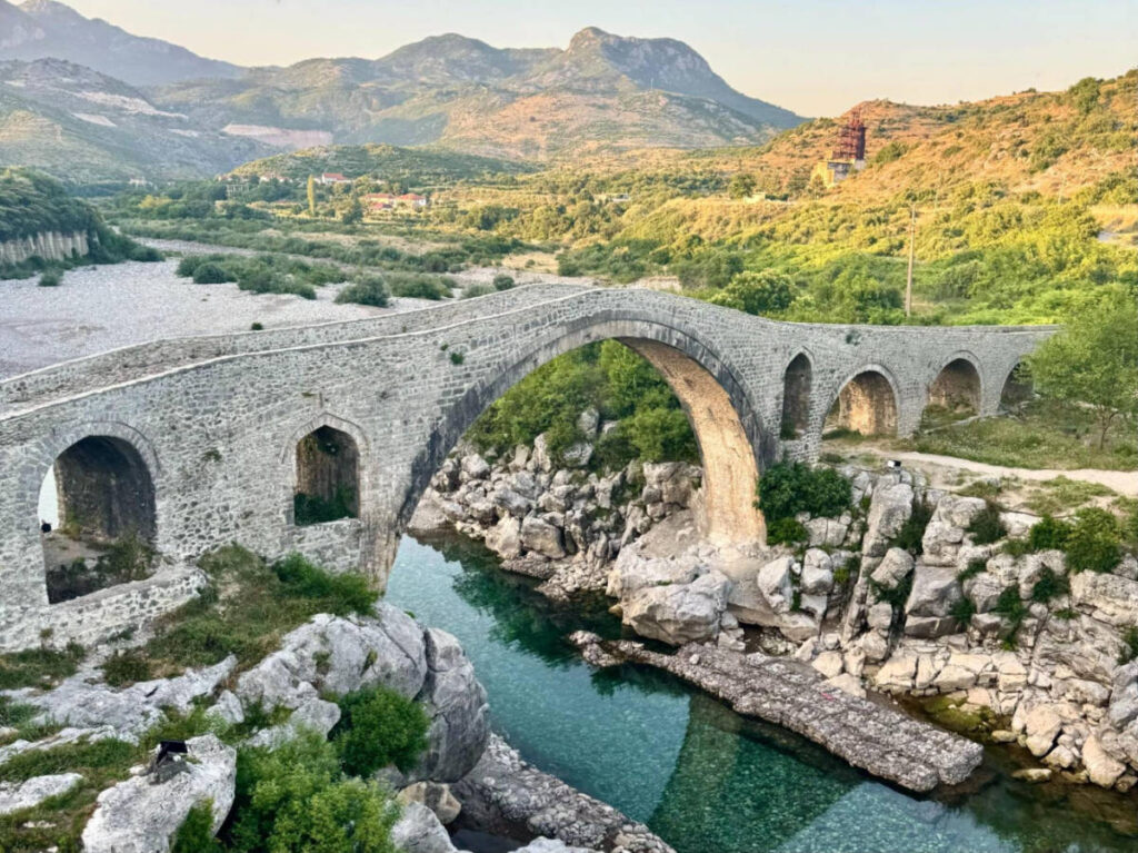 Overlooking view of the Mesi Bridge ruins surrounded by greenery