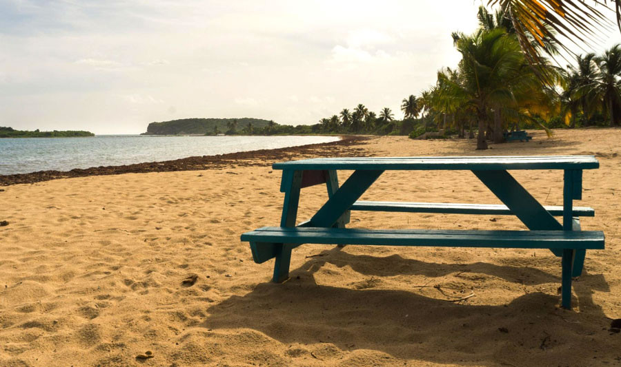 View of a table on the sand in Sun Bay Beach in Vieques