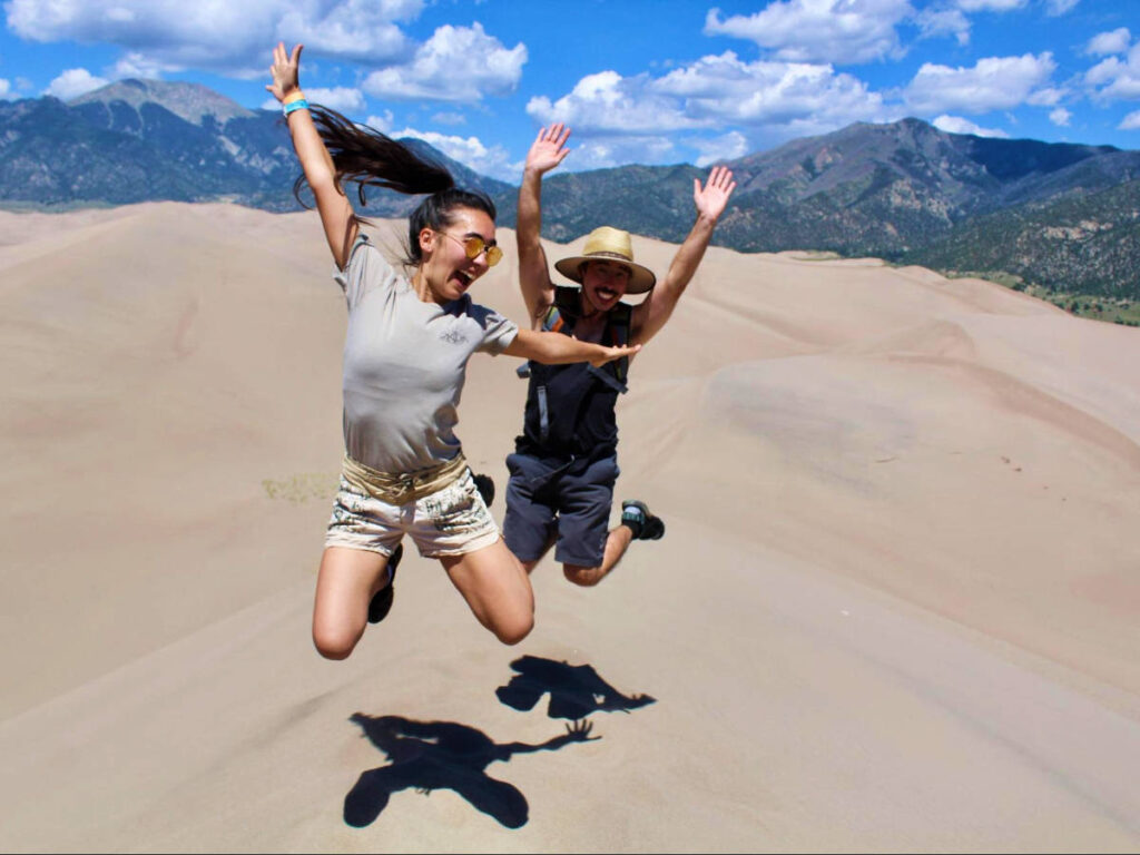 Travel Lemming editor, Abigail Bliss with her brother taking a jump shot at the top of High Dune
