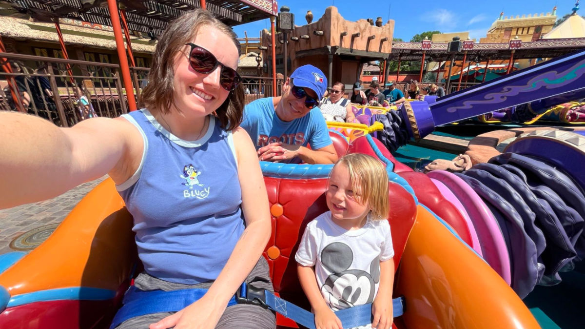 Travel Lemming author Katie and her family enjoying The Magic Carpets of Aladdin ride
