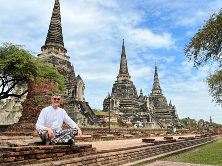 Travel Lemming Founder Nate Hake, sitting in front of temples at Ayutthaya