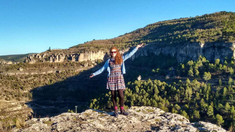 The author Ruthie Walters, posing for a photo on top of the rock in Cuenca, Spain