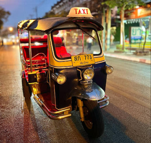 A tuk tuk at night in a road in Thailand