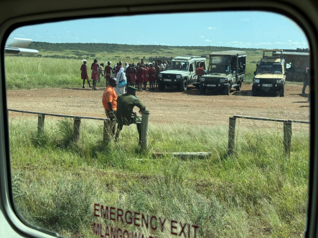The staff and the safari vehicle awaiting at the arrival area in Masai Mara