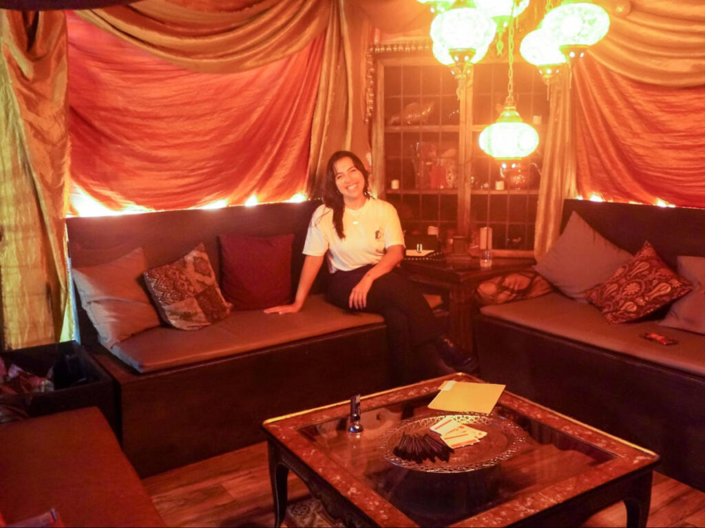 The author Vanessa Ramos, sitting inside a bar in San Juan