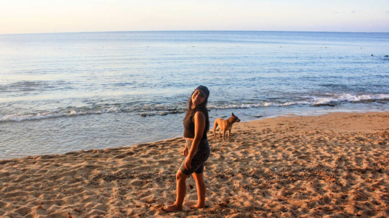 The author, Vanessa Ramos posing for a photo at Seven Seas Beach at sunset
