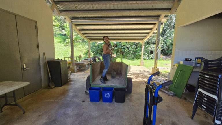 The author Vanessa Ramos holding a shovel on the tractor