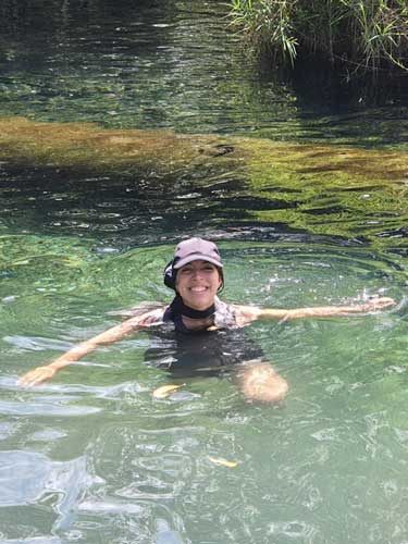 Vanessa Ramos smiling for a photo while in a Water Spring in Arecibo