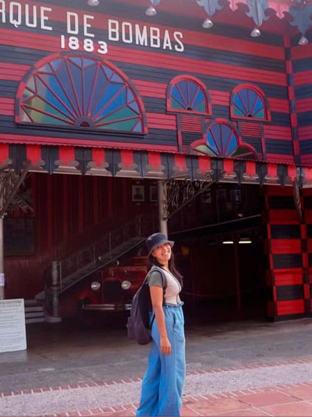 Vanessa Ramos posing for a photo in front of the Parque de Bombas in Ponce