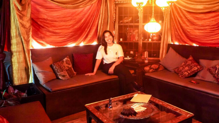 The author Vanessa Ramos sitting inside Scryer Rum Barrelhouse & Rooftop