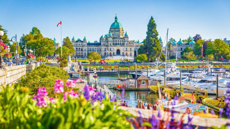 Picturesque view of the vibrant flowers in front of Victoria’s Inner Harbour and Parliament Buildings
