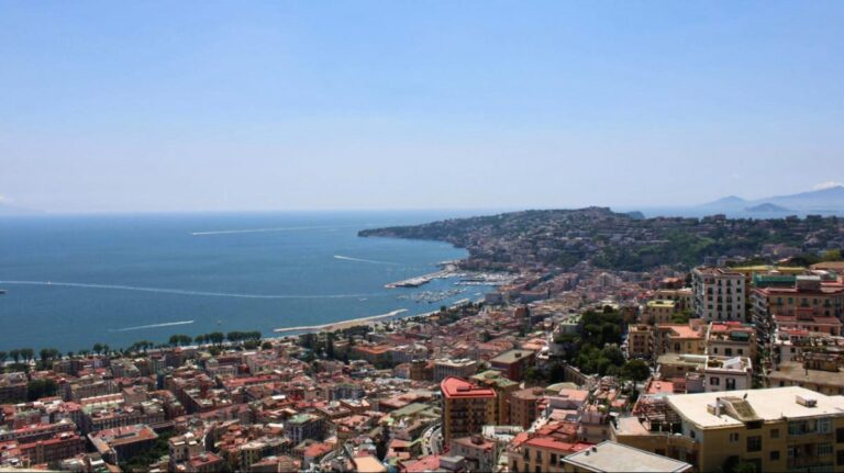 Aerial view of the cityscape and the coastline in Naples on a sunny day