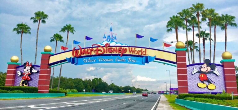 Entrance sign of Disney World featuring Mickey and Minnie Mouse