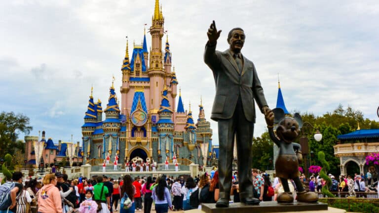 The statue of Walt Disney and Mickey Mouse in front of Cinderella's castle at Walt Disney World