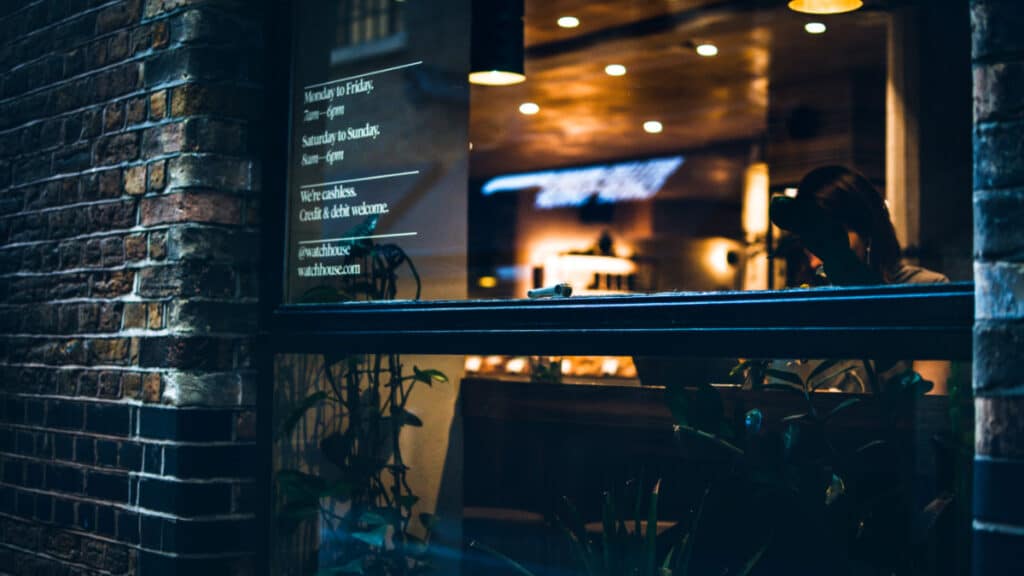 Exterior view of WatchHouse Coffee from the street at dusk