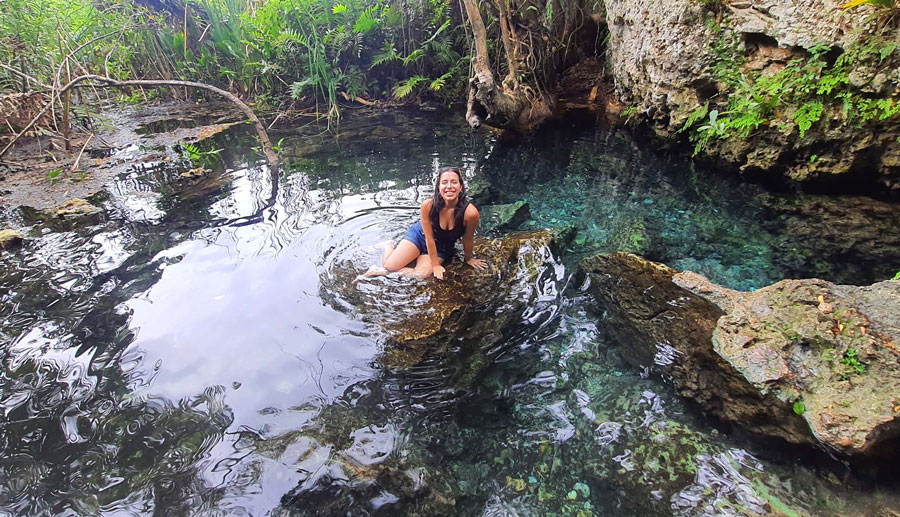 View of the author sitting in the water spring of Manati