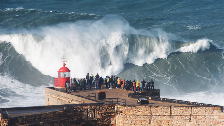 People watching the waves at the Nazare Lighthouse