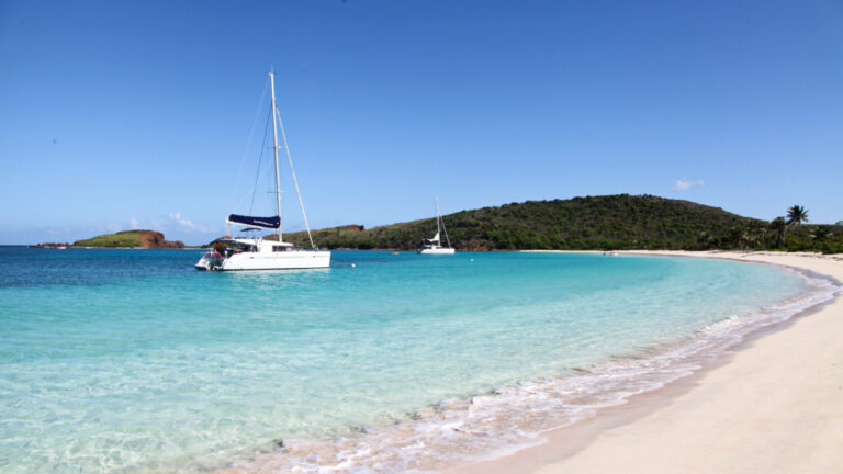 Scenic view of the catamaran and mountain views from the white sand beach in Culebra