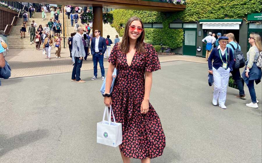 The author smiling for a photo in Wimbledon